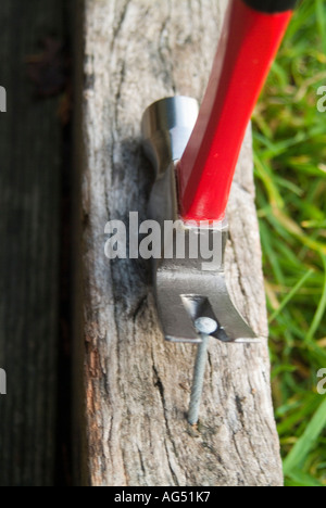 Claw hammer pulling large nail Stock Photo