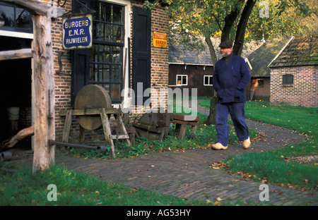 Netherlands Staphorst Farmer wearing clogs walking on path Stock Photo