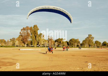 a powered paraglider pilot taking off in a tricycle frame Stock Photo