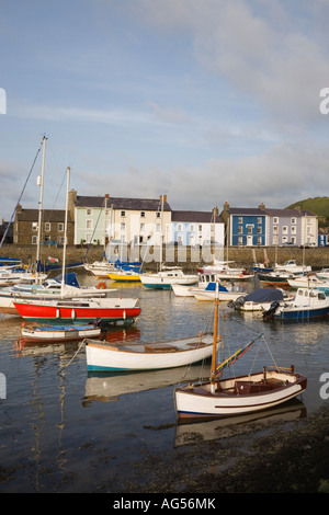 View across harbour with boats moored and colourful Georgian quayside houses in seaside town Aberaeron Ceredigion Mid Wales UK Stock Photo