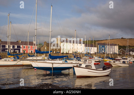 View across muddy harbour at low tide with boats moored and quayside houses in seaside town Aberaeron Ceredigion Mid Wales UK Stock Photo