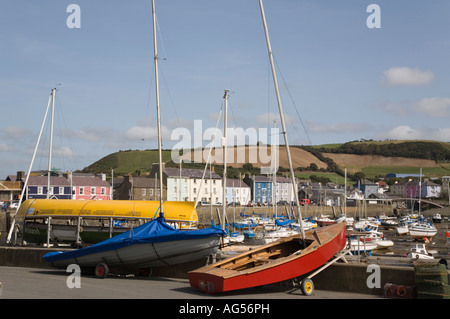 Boats on quay by Yacht Club with harbour and quayside houses beyond in seaside town of Aberaeron Ceredigion Mid Wales UK Britain Stock Photo