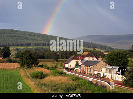 Rainbow and storm over Crowdale Old Railway Station, Speyside Scotland UK Stock Photo