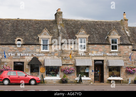 Whisky Castle advertisement, Finest malt whiskies, Scottish blends retail whisky bottle traditional built stone tourist shop in Tomintoul Scotland, UK Stock Photo