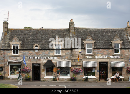 Whisky Castle advertisement, Finest malt whiskies, Scottish blends retail whisky bottle traditional built stone tourist shop in Tomintoul Scotland, UK Stock Photo