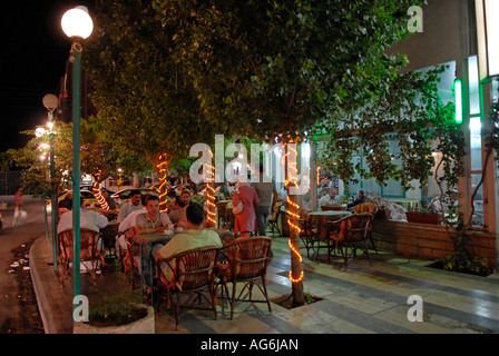 An alley lined with cafes and restaurants with people sitting at tables outside in the Shmeisani area Amman Jordan Stock Photo