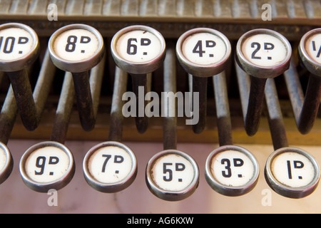 Old fashioned cash till showing shillings and pence on numbered keys Stock Photo