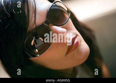 close up portrait of young woman wearing sunglasses Stock Photo