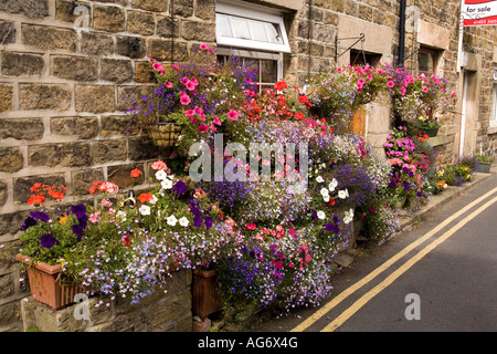 UK Yorkshire Nidderdale Pateley Bridge Church Street floral display of planters outside Winn Cottage Stock Photo