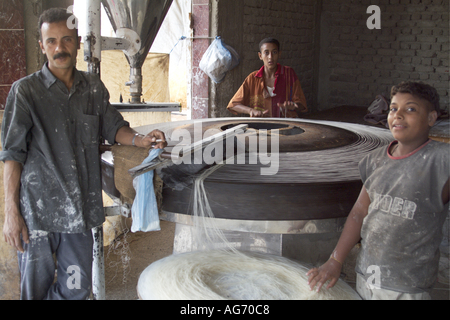 Portrait of a man and his young employees in a small noodle factory, Al-Qusair, Egypt. Stock Photo