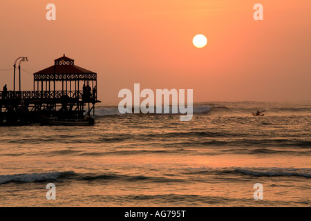 Huanchaco beach resort near Trujillo with a solitary man fishing on his caballito northern Peru Stock Photo