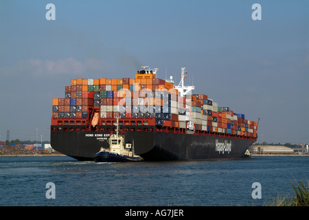 Tug Svitzer Sarah pulling Hong Kong Express a container ship operated by Hapag Lloyd from the quayside Southern England UK Stock Photo