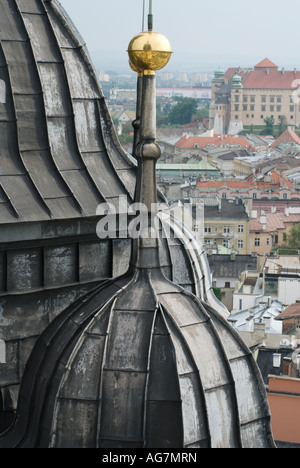 Architectural detail,dome and golden ball on St Mary's Gothic church in Rynek Glowny square with view of Krakow rooftops Poland Stock Photo