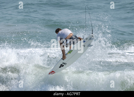 Pro surfer Dane Reynolds performing an aerial maneuver on waves in huntington beach California Stock Photo