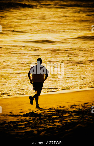Silhouette of man running on beach Stock Photo