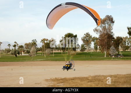 a powered paraglider pilot taking off with a passenger Stock Photo