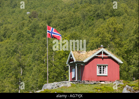 Wooden cabin and Norwegian flag in Innerdalen Sunndal More og Romsdal Norway Stock Photo