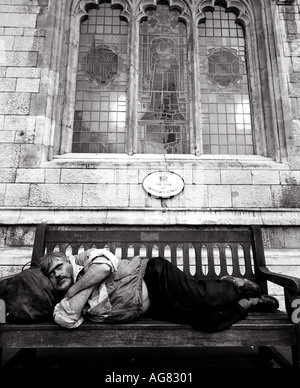 Homeless man sleeping on bench in a public park Stock Photo - Alamy