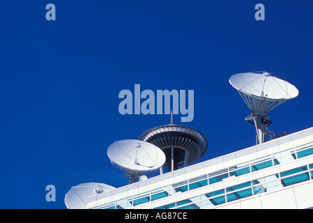 Seattle Space Needle peeking over top of building with satellite dishes Stock Photo