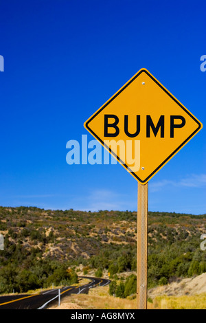 Road sign warning of bumpy road ahead Stock Photo