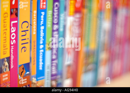 Selection of Travel Guide Books to various destinations on a shelf Stock Photo