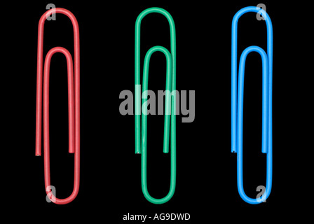Office Paperclips against a Black Background Three Objects Arranged as Red Green and Blue Stock Photo