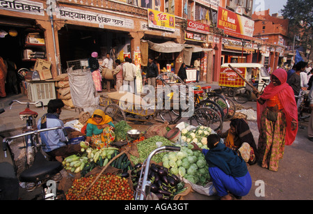 India, Rajasthan, Jaipur, Woman selling vegetable in marketplace on street Stock Photo