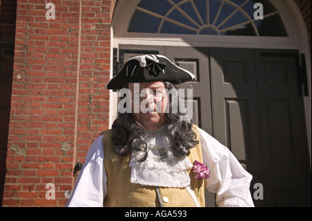 A colonial costumed gentleman dressed to look like Benjamin Franklin poses for photographs at Faneuil Hall in Boston MA Stock Photo