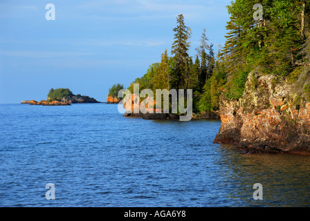 Michigan Isle Royale National Park small rocky islands forest orange algae skyline Stock Photo