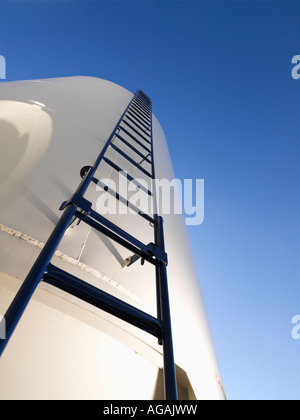 Low angle view of metal grain storage silo with ladder assending to top Stock Photo