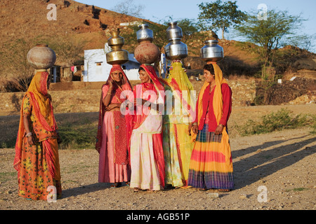Women carrying water in the traditional way from a well outside of Pushkar India Models released Stock Photo