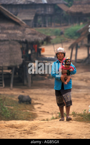 Laos, Luang Namtha, Woman of Hakha or Akha Hill Tribe with baby girl Stock Photo