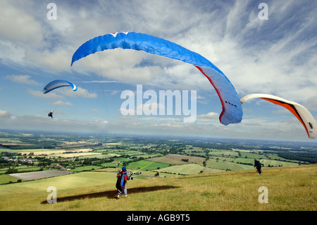 Daredevil paragliders practice on a breezy summer day. Stock Photo