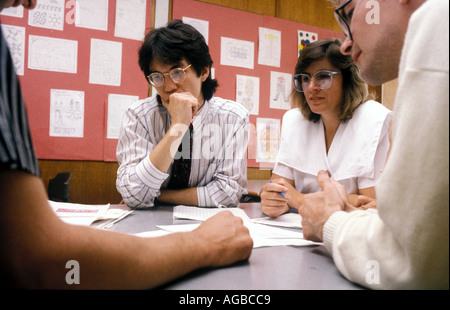 School teachers discussing their day's work during staff meeting. Stock Photo