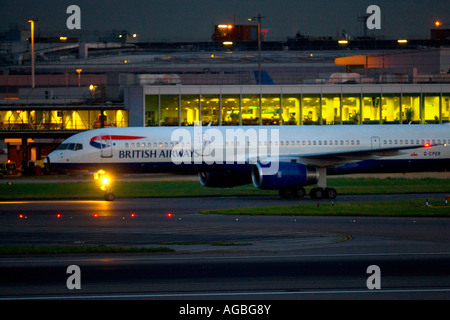 Commercial civil aviation British Airways BA Boeing 757 at London Heathrow Airport UK at night Stock Photo