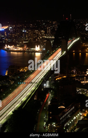 High level aerial oblique view at twilight night or dusk of Harbour Bridge with light trails in Sydney New South Wales NSW Aust