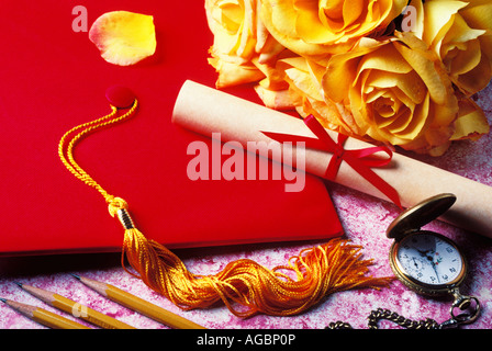 Red graduation cap and yellow roses Stock Photo