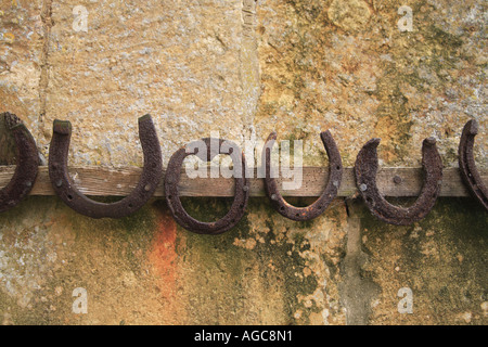 Horseshoes Hanging on a Cotswold Wall Stock Photo