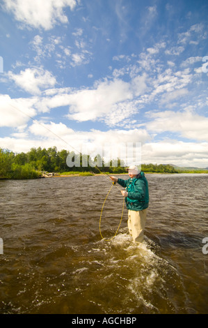 Alaska Southwest Mature Fly fisherman casting while fishing on the King Salmon River for trout and salmon Stock Photo