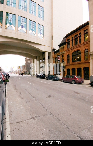 Downtown Lansing Michigan USA. Old buildings contrasted against the new city hall which arches over the street. Stock Photo