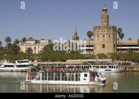 Seville Spain Tour boat in front of Torre del Oro La Giralda tower background Stock Photo