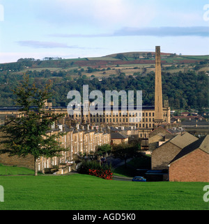 The town of Saltaire was purpose built in the 1850s by Sir Titus Salt the mill seen here dominates the town and overlooks the terraced rows which housed the workers Stock Photo