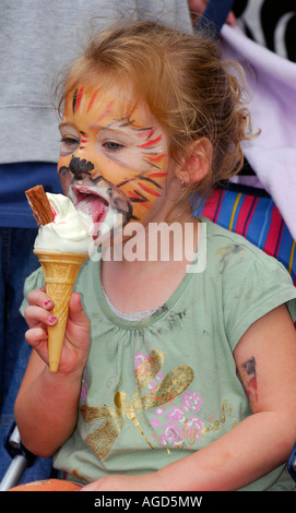 3 year old girl eating ice cream at a community fun day Fulham London Stock Photo