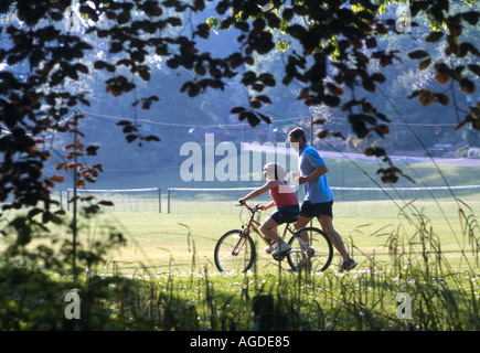 Father teaching his daughter to ride a bike Alexandra Park Hastings East Sussex UK Stock Photo