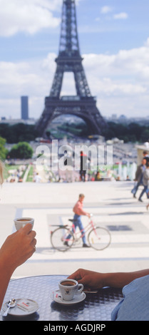 Couple having coffee at Trocadero cafe with Eiffel Tower in Paris Stock Photo