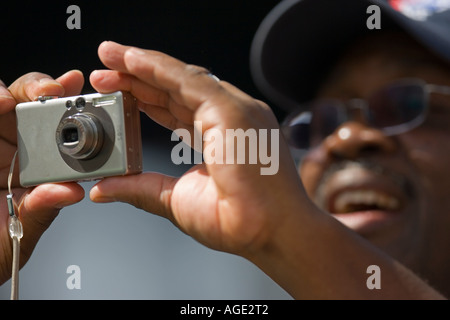 Man taking a picture with a digital camera Stock Photo