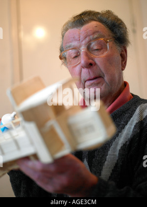 old man working on hobby of modeling Stock Photo