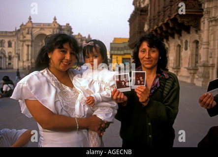 3, three, Peruvians, Peruvian women, mother and daughter, little girl, girl, toddler, baptism, christening, Plaza de Armas, Lima, Lima Province, Peru Stock Photo