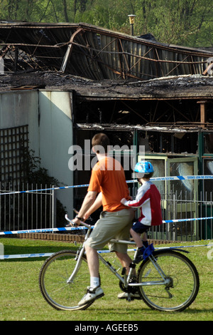 Locals look at the tangled remains of Rogerstone Primary School Newport after it was destroyed by fire Gwent Wales UK GB Stock Photo