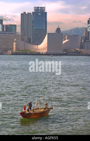 Fishing boat passing before the Hong Kong Cultural Center Kowloon China Stock Photo